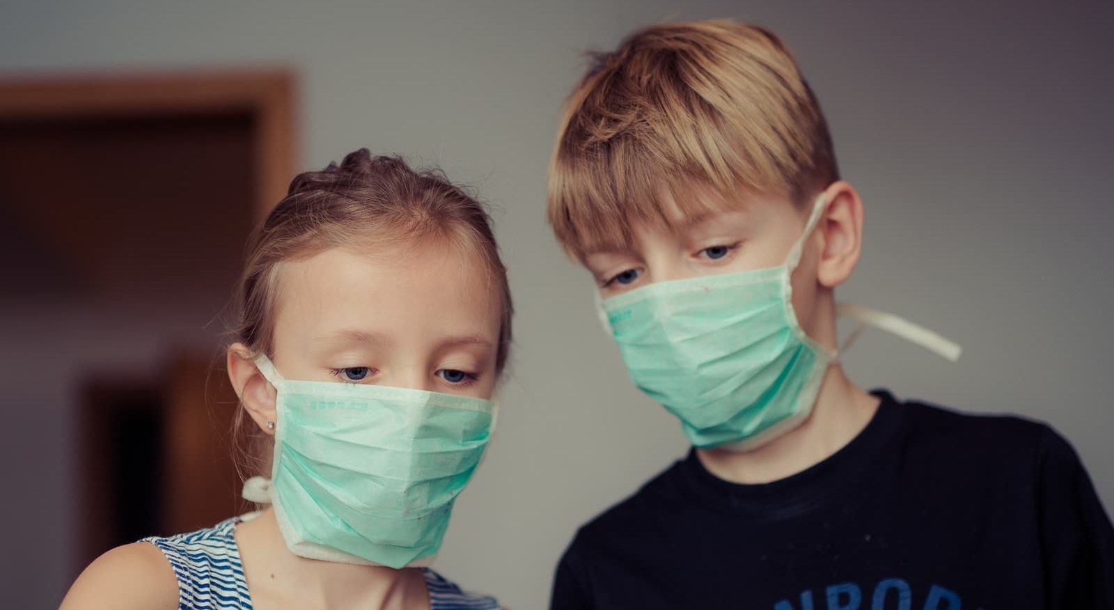 Canva - Two Children Wearing Surgical Masks